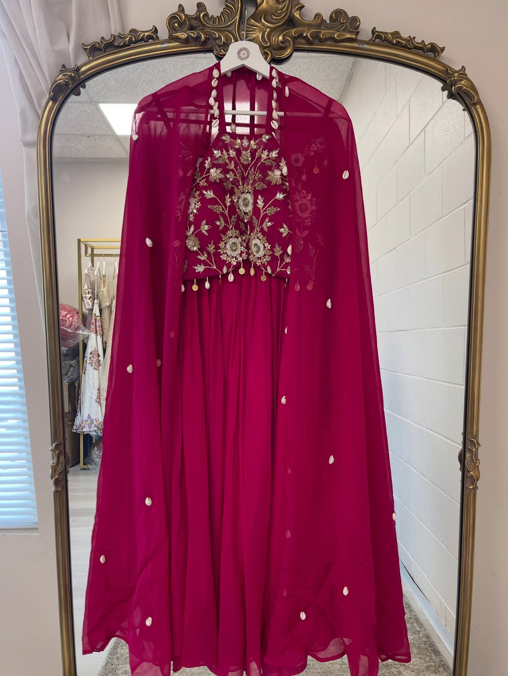 Fuchsia embroidered cape gown with floral embellished bodice and sheer cape for weddings, receptions, and festive occasions.