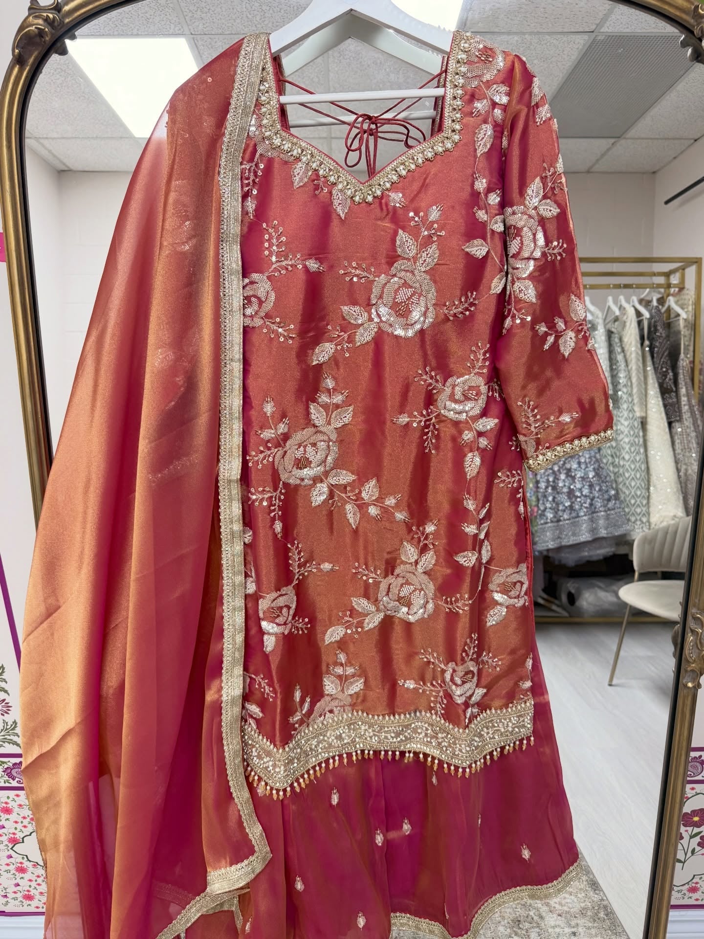 Rose pink embroidered Punjabi suit with floral embroidery, straight pants, and matching organza dupatta for weddings and festive occasions.